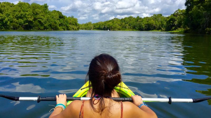 A kayaker takes in the view on the water.